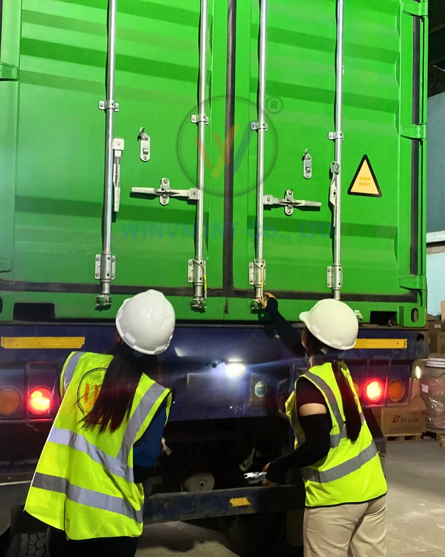Workers loading loofah cartons into a shipping container