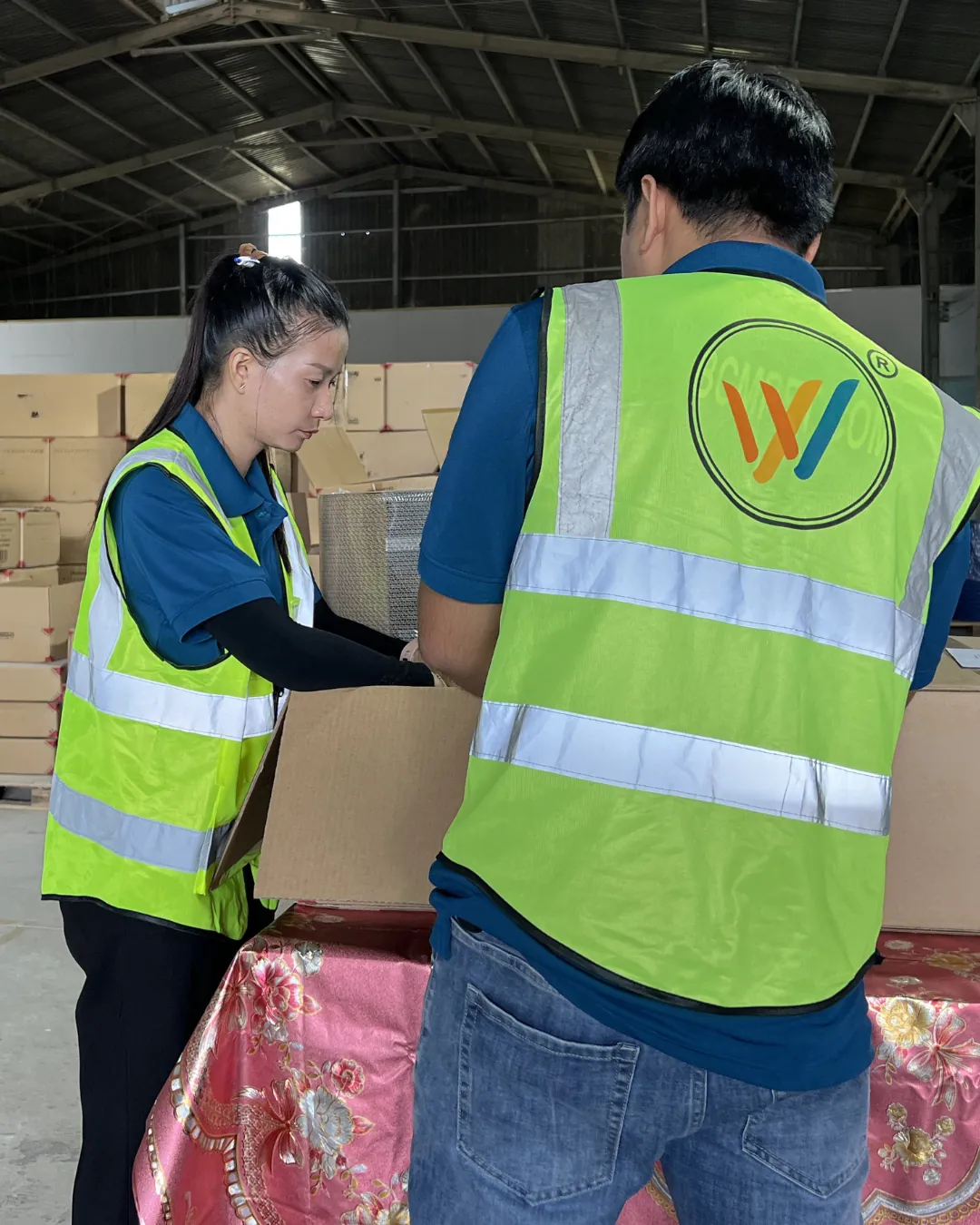 EcoLoofahVN staff in safety vests inspecting product inside export cartons
