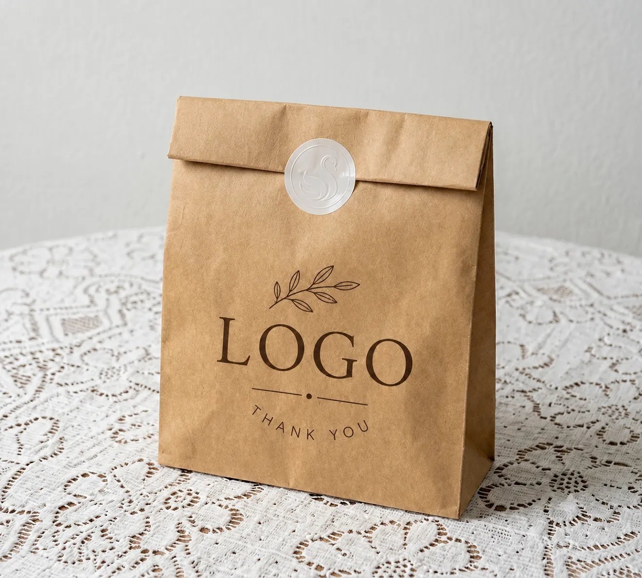 Kraft paper bag with a printed logo placeholder, a packaging design mockup