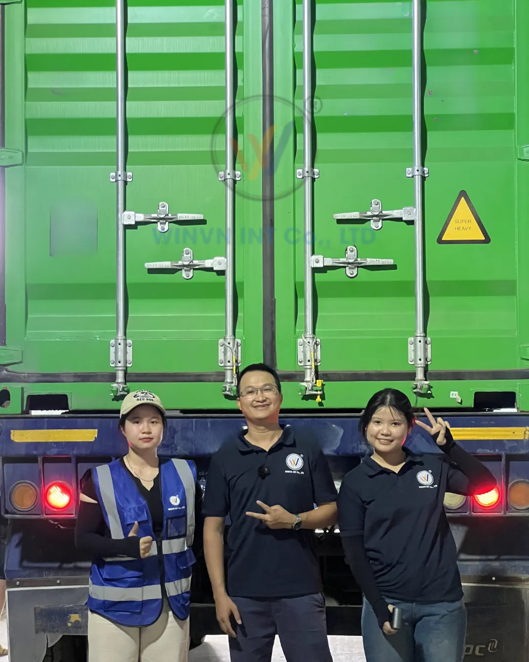 EcoLoofahVN team standing in front of a sealed green shipping container