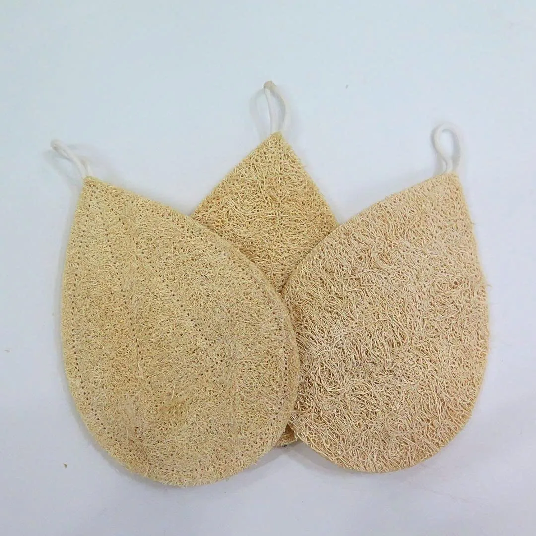 Three teardrop shaped natural loofah sponges with hanging loops on a white background