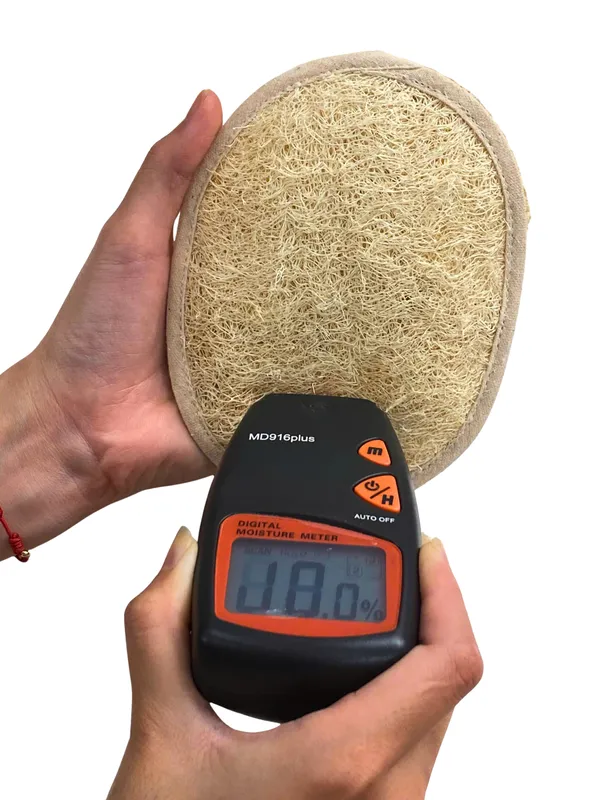 Moisture meter check on loofah pad — moisture kept at 12% or below